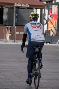 cyclist holding energy gel wrapper jersey pocket