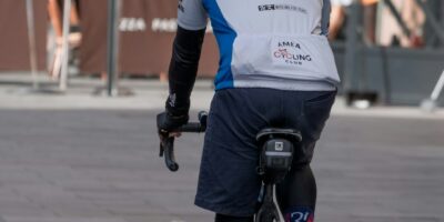 cyclist holding energy gel wrapper jersey pocket