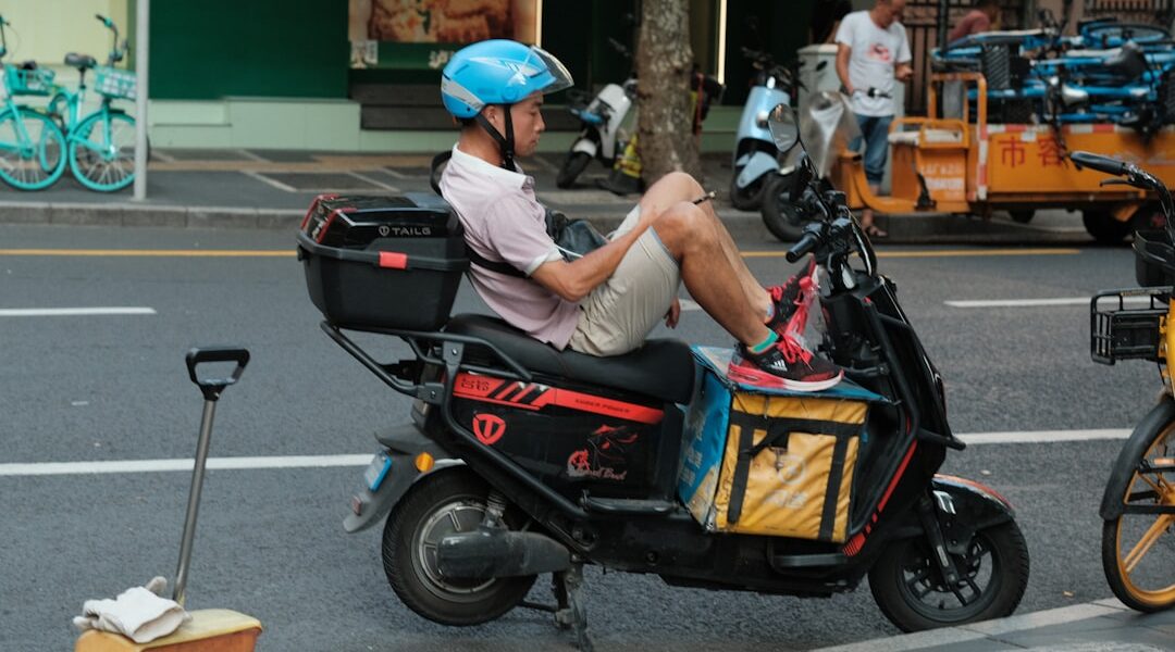 cyclist eating peanut butter sandwich on road bike
