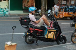 cyclist eating peanut butter sandwich on road bike