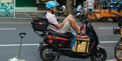 cyclist eating peanut butter sandwich on road bike